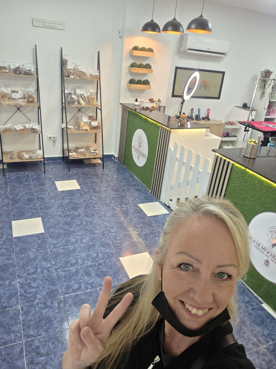 Shelving stocked with natural dog treats and chews at Jodie's Groom Room salon, Alicante